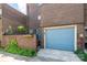 Brick exterior with blue garage door, landscaping, and entry door at 217 W 8Th St, Charlotte, NC 28202