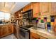 Charming kitchen featuring stainless steel appliances, colorful backsplash, and custom wooden cabinetry at 217 W 8Th St, Charlotte, NC 28202