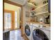 Well-organized laundry area with modern washer and dryer, shelving, and a bright, tiled floor at 217 W 8Th St, Charlotte, NC 28202