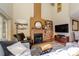 Spacious living room with a cozy fireplace, wooden floors, a large window and comfortable seating at 217 W 8Th St, Charlotte, NC 28202