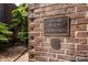 Exterior shot of the 'Poplar Place Townhomes' signage on a brick wall with unit numbers at 217 W 8Th St, Charlotte, NC 28202
