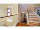 Modern staircase with wood treads, metal railing, and a stained glass window feature at 217 W 8Th St, Charlotte, NC 28202