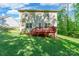View of a two-story home featuring a backyard and a red deck, perfect for outdoor living and entertaining at 2202 Chickasaw Loop, Rock Hill, SC 29732
