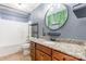 Bathroom features vanity with granite countertop, bathtub with shower, decorative mirror and tile floor at 2202 Chickasaw Loop, Rock Hill, SC 29732