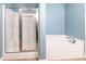 Bright bathroom featuring a tub, tiled floors, a shower with sliding glass doors and pale blue walls at 2202 Chickasaw Loop, Rock Hill, SC 29732