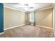 Bright carpeted bedroom with ceiling fan and window letting in natural light at 2202 Chickasaw Loop, Rock Hill, SC 29732