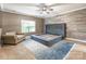 Bedroom with wood accent wall, ceiling fan, and stylish platform bed frame with area rug at 2202 Chickasaw Loop, Rock Hill, SC 29732
