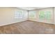 Bedroom featuring neutral paint and carpet with three sunny windows at 2202 Chickasaw Loop, Rock Hill, SC 29732