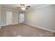 Large bedroom featuring neutral walls, plush carpet, and a ceiling fan fixture at 2202 Chickasaw Loop, Rock Hill, SC 29732