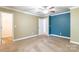 Carpeted bedroom with a ceiling fan and a blue accent wall at 2202 Chickasaw Loop, Rock Hill, SC 29732