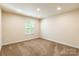 Bright, sunny bedroom with neutral carpet and paint, recessed lighting, and a large window at 2202 Chickasaw Loop, Rock Hill, SC 29732
