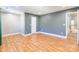 Large bonus room with door, gray accent wall, and wood floors at 2202 Chickasaw Loop, Rock Hill, SC 29732