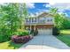 Charming two-story home with a brick facade, a two car garage, and inviting, landscaped front yard at 2202 Chickasaw Loop, Rock Hill, SC 29732