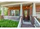 Inviting front porch with brick columns, a white railing, and a cozy welcome mat at 2202 Chickasaw Loop, Rock Hill, SC 29732
