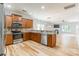 Modern kitchen with wood cabinets, stainless steel appliances, and an open view into the adjacent living area at 2202 Chickasaw Loop, Rock Hill, SC 29732
