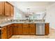 Functional kitchen space featuring stainless steel appliances, wood cabinetry, and a clear view of the living area at 2202 Chickasaw Loop, Rock Hill, SC 29732