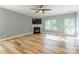 Bright living room showcasing a fireplace, ceiling fan, and a doorway to an outside deck at 2202 Chickasaw Loop, Rock Hill, SC 29732