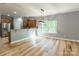 Open living space with hardwood floors, updated kitchen, and large windows for ample light at 2202 Chickasaw Loop, Rock Hill, SC 29732