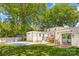 Expansive backyard with a pool, patio, deck, fire pit and lush green lawn, perfect for outdoor living at 2411 Ainsdale Rd, Charlotte, NC 28226