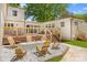 Inviting backyard featuring a fire pit with Adirondack chairs, a wooden deck, and well-maintained landscaping at 2411 Ainsdale Rd, Charlotte, NC 28226