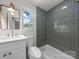 Charming bathroom featuring gray tile and white vanity at 2411 Ainsdale Rd, Charlotte, NC 28226