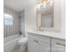 Bright bathroom with white vanity, tub, shower and stylish fixtures at 2411 Ainsdale Rd, Charlotte, NC 28226