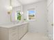 Clean bathroom with a large mirror, white marble counters, and custom fixtures at 2411 Ainsdale Rd, Charlotte, NC 28226