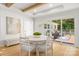 Bright dining area with hardwood floors, modern table and chairs, and access to outdoor deck through sliding glass doors at 2411 Ainsdale Rd, Charlotte, NC 28226