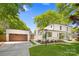 Charming white home featuring an attached garage, manicured lawn, and professionally landscaped front yard at 2411 Ainsdale Rd, Charlotte, NC 28226