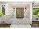 Elegant double front door with sidelights framed by white painted brick and exterior lanterns at 2411 Ainsdale Rd, Charlotte, NC 28226