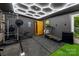 Well-equipped home gym with modern exercise equipment, and unique honeycomb ceiling lights at 2411 Ainsdale Rd, Charlotte, NC 28226