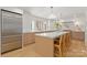 Kitchen island with marble countertop and breakfast bar seating with stainless refrigerator at 2411 Ainsdale Rd, Charlotte, NC 28226