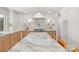 Bright kitchen featuring a marble island, countertops, and backsplash with stainless steel appliances at 2411 Ainsdale Rd, Charlotte, NC 28226