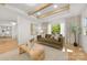 Comfortable living room with hardwood floors, coffered ceilings, a green sofa, and a decorative coffee table at 2411 Ainsdale Rd, Charlotte, NC 28226