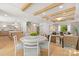 Open-concept living space with hardwood floors, exposed beams, and seamless flow between dining, living, and kitchen areas at 2411 Ainsdale Rd, Charlotte, NC 28226