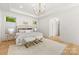Bright main bedroom with an accent wall and plush furniture, including a decorative chandelier at 2411 Ainsdale Rd, Charlotte, NC 28226