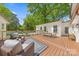 Comfortable patio features an outdoor dining and living area with a peek at the pool at 2411 Ainsdale Rd, Charlotte, NC 28226