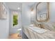 Elegant powder room with marble countertop, gold fixtures, and natural light from the window at 2411 Ainsdale Rd, Charlotte, NC 28226