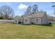 Large backyard with a patio and grill next to a well-maintained house with a fenced perimeter at 247 Timberland Loop, Mooresville, NC 28115