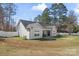 Spacious backyard featuring a patio area, lush lawn, and a charming single-story home exterior at 247 Timberland Loop, Mooresville, NC 28115
