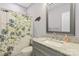 Cozy bathroom featuring a granite countertop vanity and shower with a tropical curtain pattern at 247 Timberland Loop, Mooresville, NC 28115