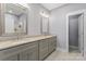 Bathroom with a double vanity with granite countertop and gray cabinetry at 247 Timberland Loop, Mooresville, NC 28115