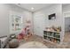 Bright bedroom features hardwood floors, a window, and shelving with toys for a play area at 247 Timberland Loop, Mooresville, NC 28115