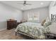 Bright bedroom with hardwood floors, ceiling fan, and a floral patterned comforter at 247 Timberland Loop, Mooresville, NC 28115