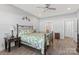 Bedroom features a decorative metal bedframe, wood flooring, ceiling fan, and modern lighting at 247 Timberland Loop, Mooresville, NC 28115