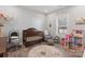 Bright Bedroom room with a crib, chair, round rug, and multiple decorations at 247 Timberland Loop, Mooresville, NC 28115