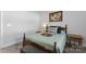 Bedroom features a wooden bed frame, hardwood floors, a window, and side tables at 247 Timberland Loop, Mooresville, NC 28115