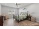 Bedroom with a wrought iron bed frame, ceiling fan, and neutral color palette at 247 Timberland Loop, Mooresville, NC 28115