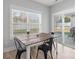 Dining table with seating for four next to a window and glass sliding door at 247 Timberland Loop, Mooresville, NC 28115