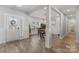 Bright dining room with hardwood floors and a view of the front door and entry area at 247 Timberland Loop, Mooresville, NC 28115